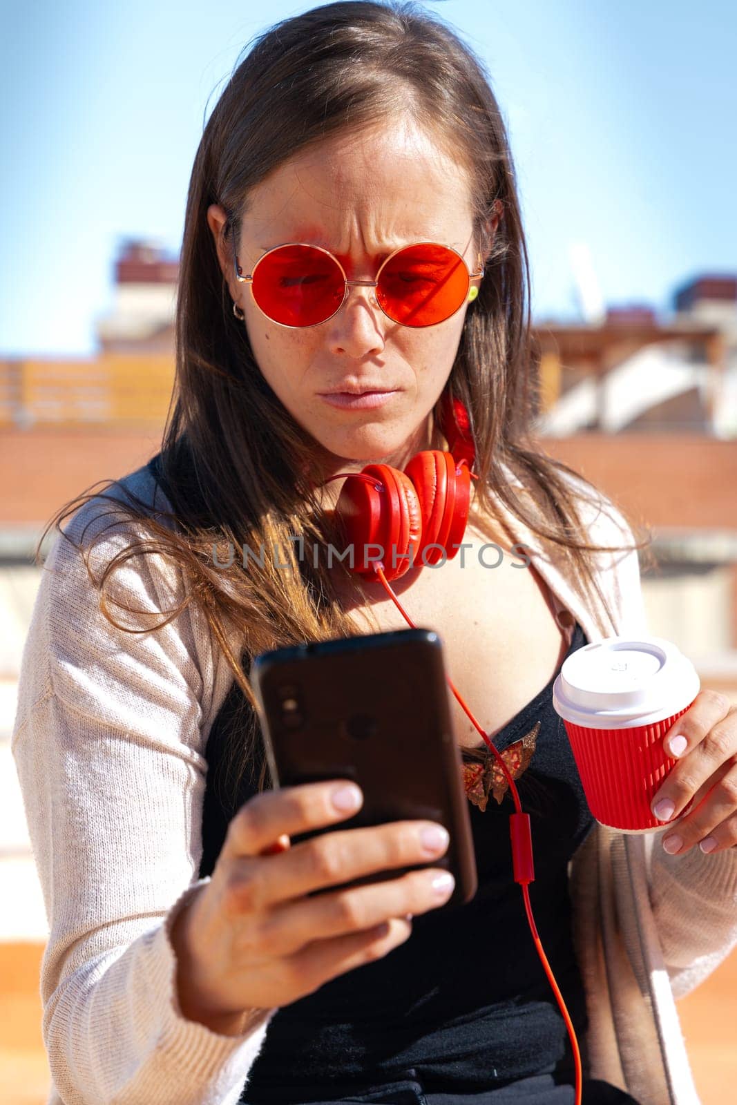 Vertical portrait young woman using smartphone app outdoors. by molesjuny