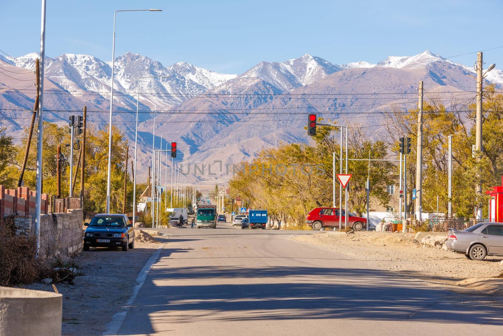 street of small Central Asia town at sunny autumn afternoon in Balykchy, Kyrgyzstan in October 21, 2022