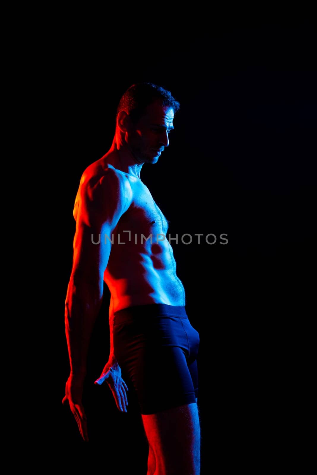 Portrait of man, bodybuilder and bicep flex in a studio, background and exercise for muscular power.