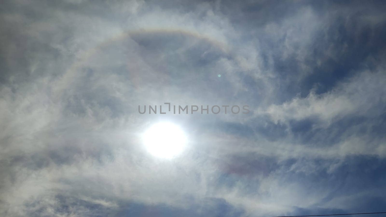 sun sky clouds rays of light background halo circle nature. High quality photo
