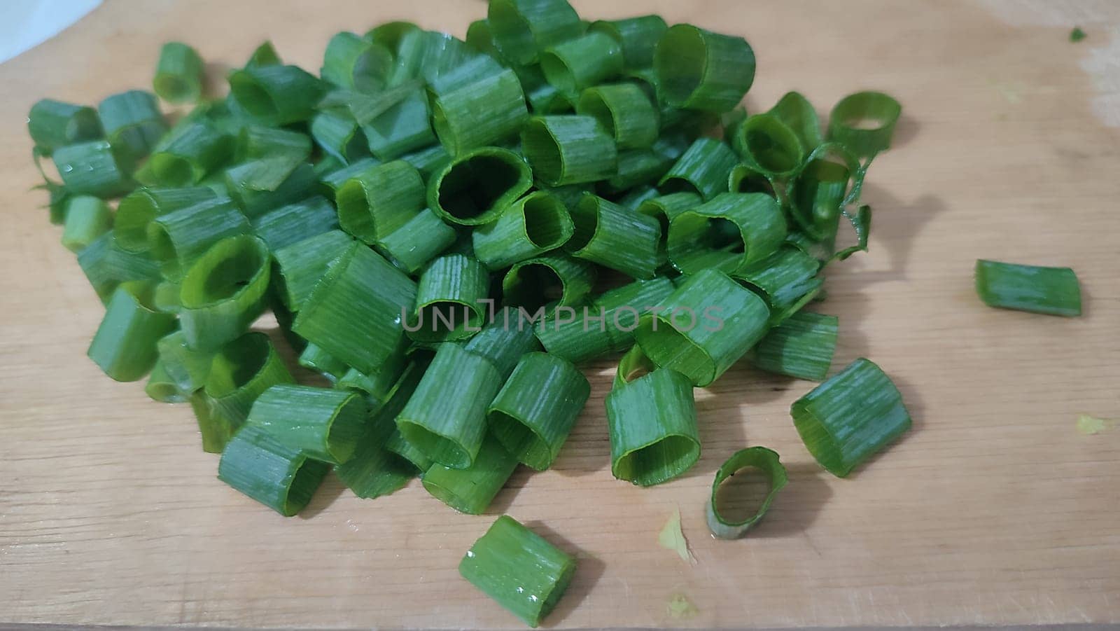 green fresh onions cut on the kitchen board, food snack. High quality photo