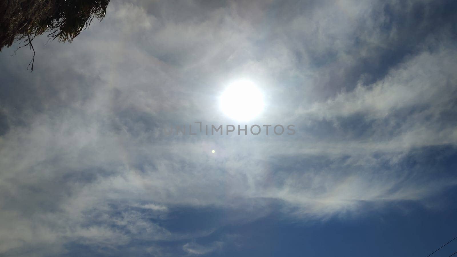 sun sky clouds rays of light background halo circle nature. High quality photo
