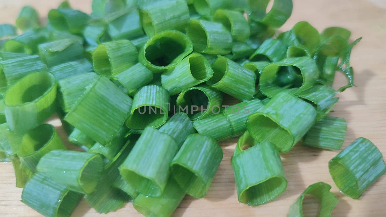 green fresh onions cut on the kitchen board, food snack. High quality photo