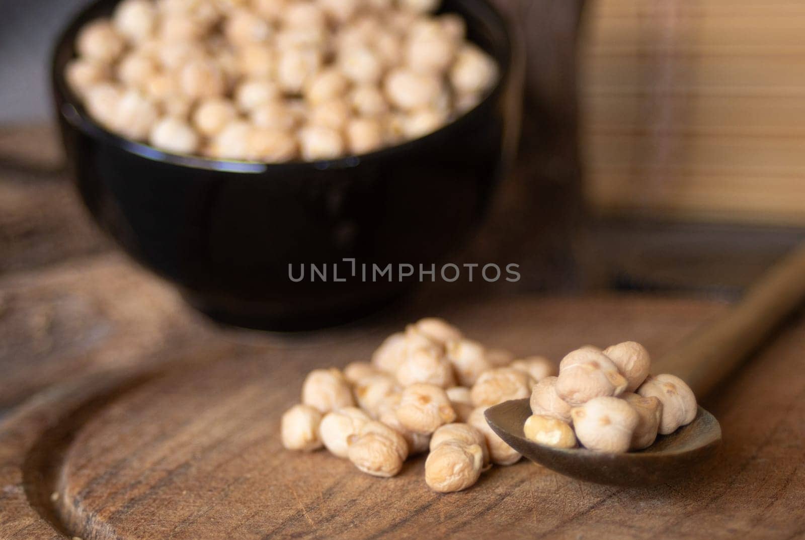 Chickpeas beans in foreground. Blurred background.Still life by VeroDibe