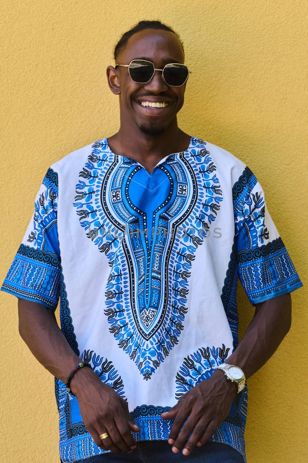 Sudanese Tradition Meets Modern Youth: African American Teen in Vibrant Traditional Attire Against a Yellow Backdrop by dotshock