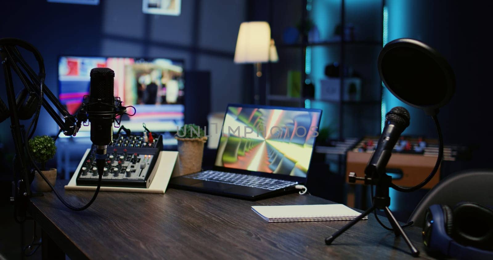 Jib down shot of wooden desk in studio with podcast gear technology recording sound for social media channel production. Live broadcasting space with specialized tech in dimly lit apartment