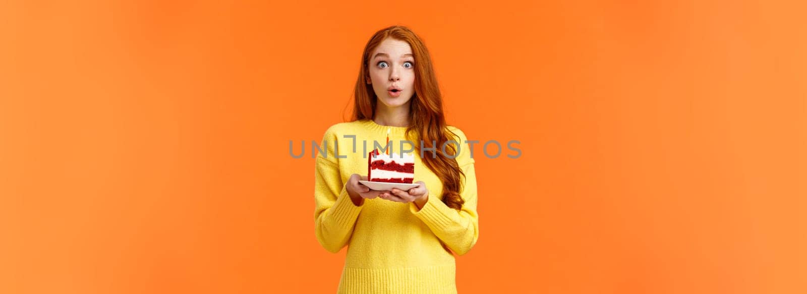 Carefree dreamy cute redhead girl making wish, quickly make-up desire to blow out candle on birthday cake, folding lips holding breath, want dream come true, look camera overwhelmed, b-day concept by Benzoix