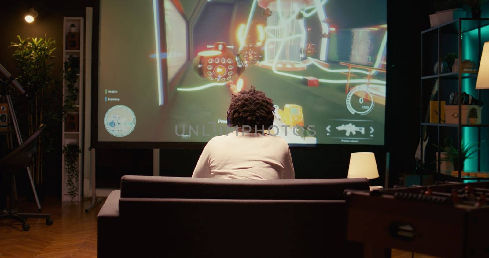 Man watching gameplay footage of videogame competition on gigantic smart TV by DCStudio