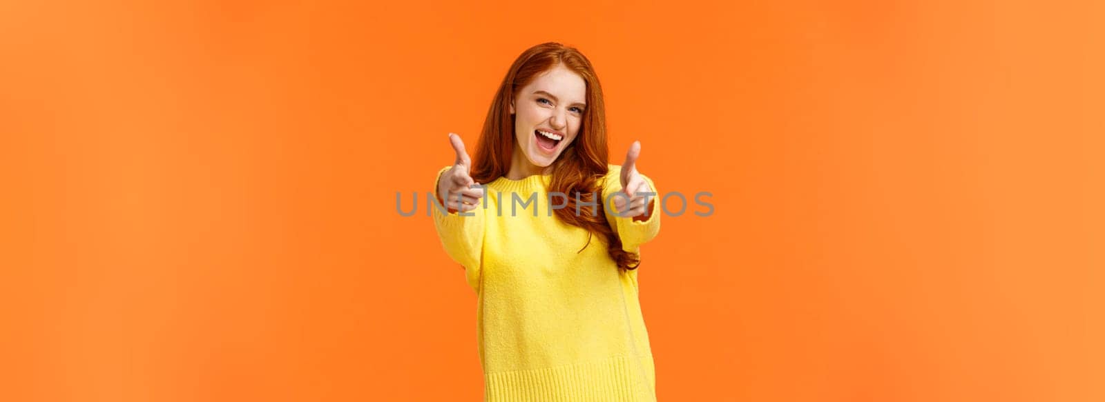 Excited, carefree cool modern hipster girl with red hair showing thumbs-up in approval, rooting for friend saying yeah, yes gesture, feeling upbeat and delighted, recommend product, fully-satisfied.