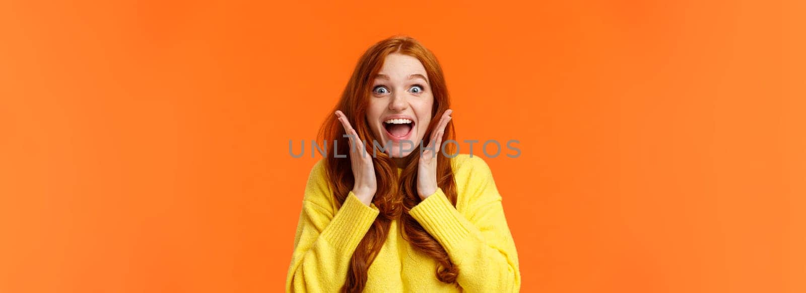 Excitement, emotions and holidays concept. Waist-up shot cheerful impressed and excited redhead woman screaming from thrill and joy, hold hands near face, open mouth and glance amazed by Benzoix