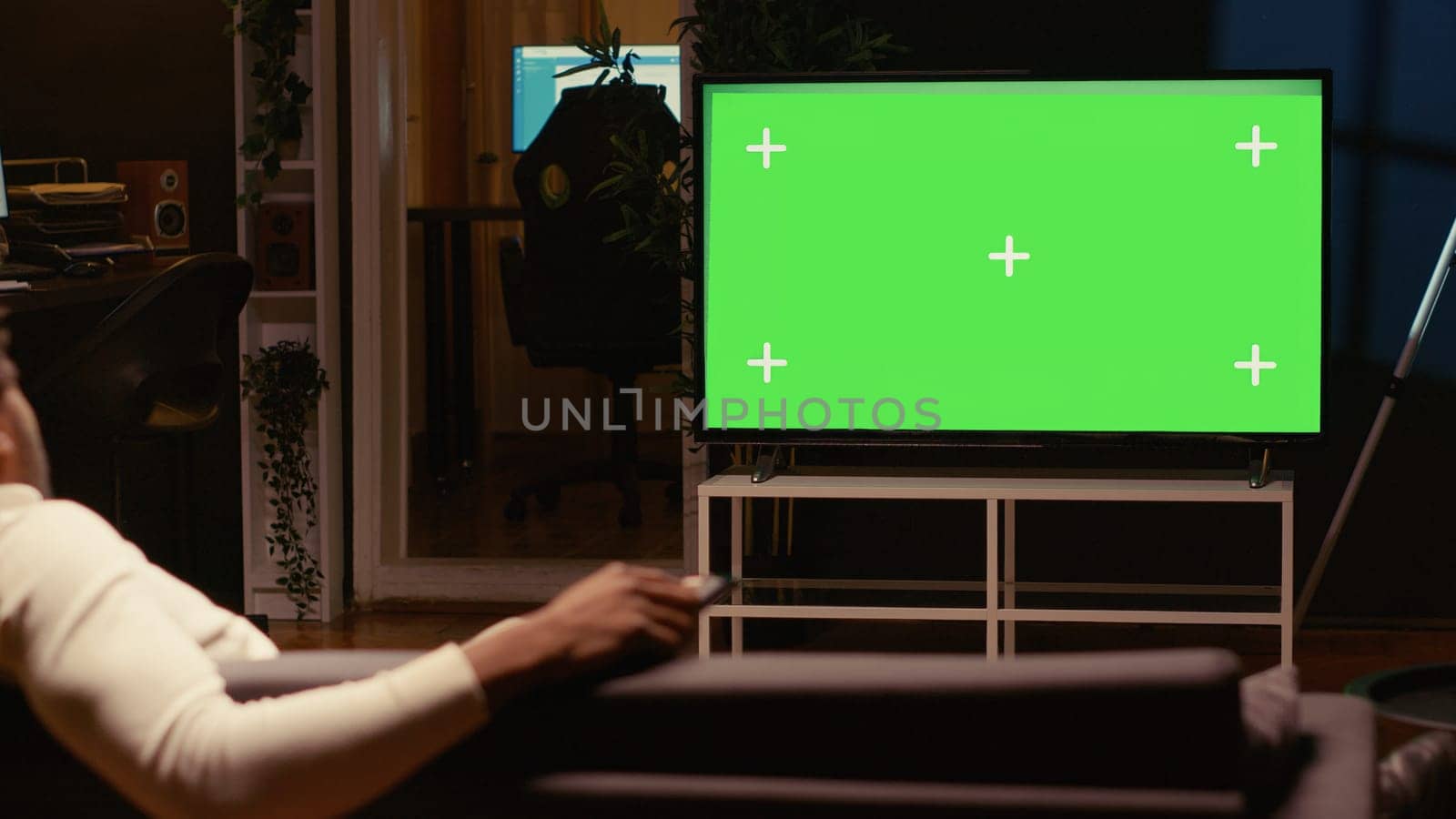 African american man using streaming services on mockup TV to binge watch series from the comfort of his apartment. Person enjoying shows on isolated screen television set during leisure time on couch