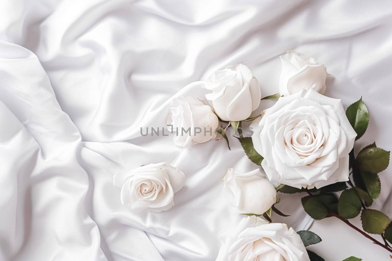 Floral composition. White flowers on white fabric. Flat lay, top view, copy space.