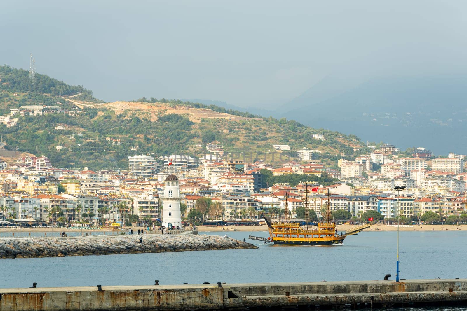 Antalya, Turkey - April 12, 2024: View of Alanya marina and walking path, one of the touristic districts of Antalya, from the Red Tower