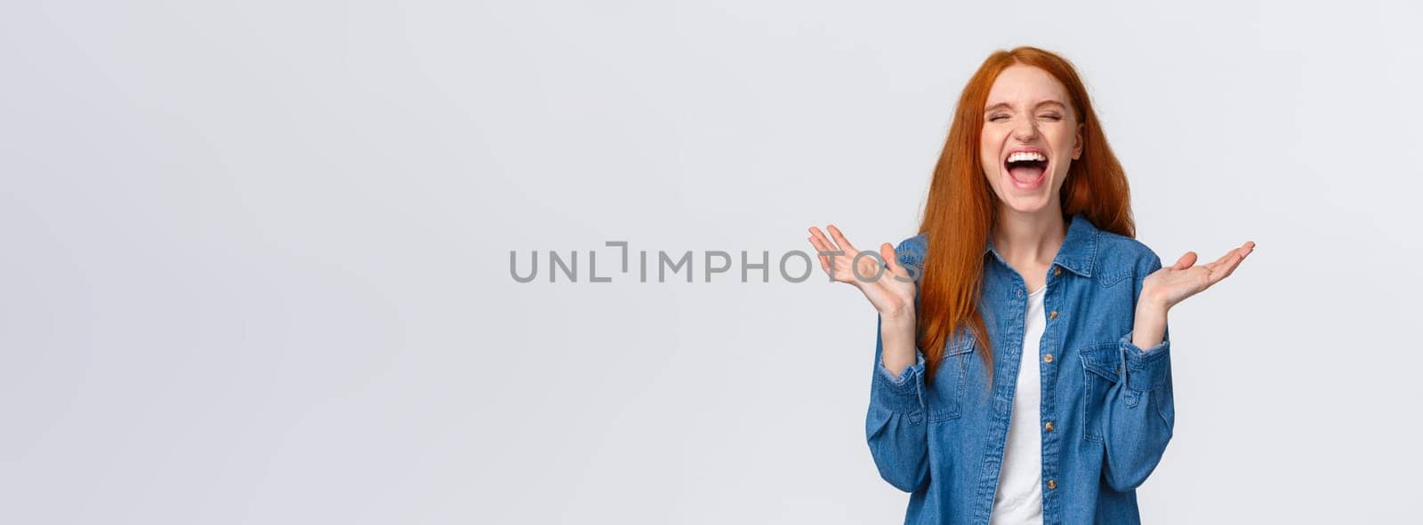 Lol so funny. Amused and carefree pretty redhead female student clap hands, applause with closed eyes as laughing out loud, having fun, hear hilarious joke, standing white background.