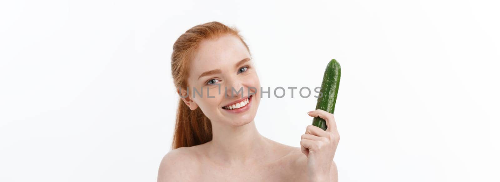 Cheerful happy beautiful girl with cucumber on her hand - isolated on white.