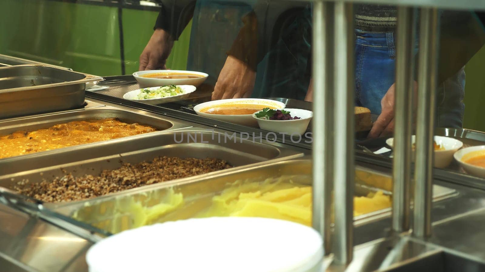 close-up, showcase with dishes in modern Self service canteen, cafeteria, mess hall, factory employees having lunch in the canteen, they are Served Meal In factory Canteen. High quality photo