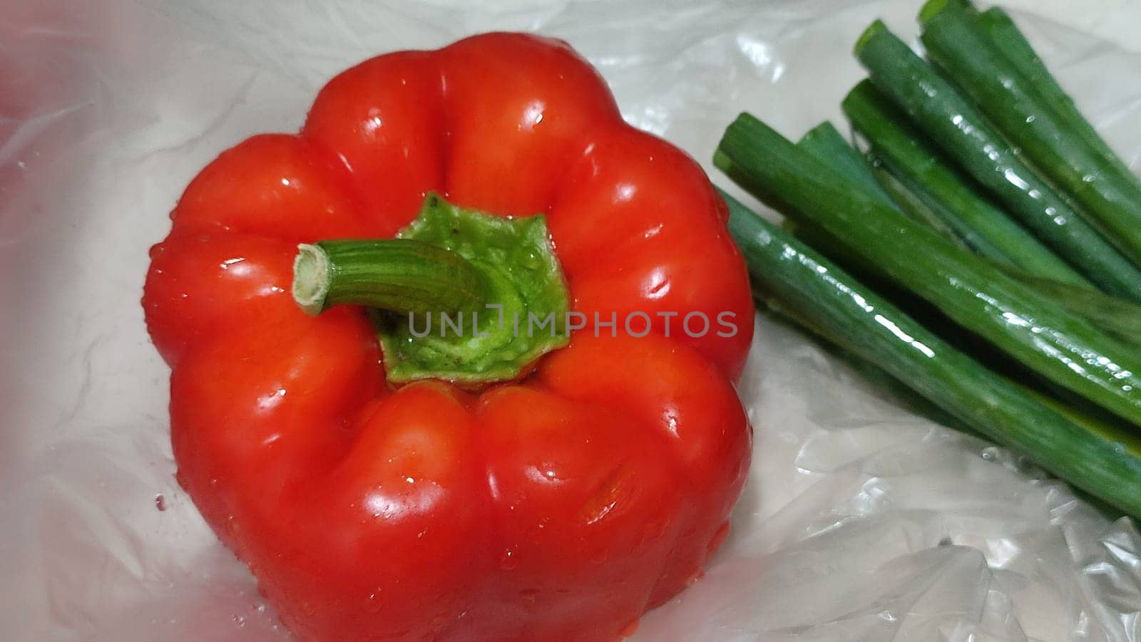 red sweet bell pepper fresh whole, green onion,food vegetables cooking vegetarian nature. High quality photo