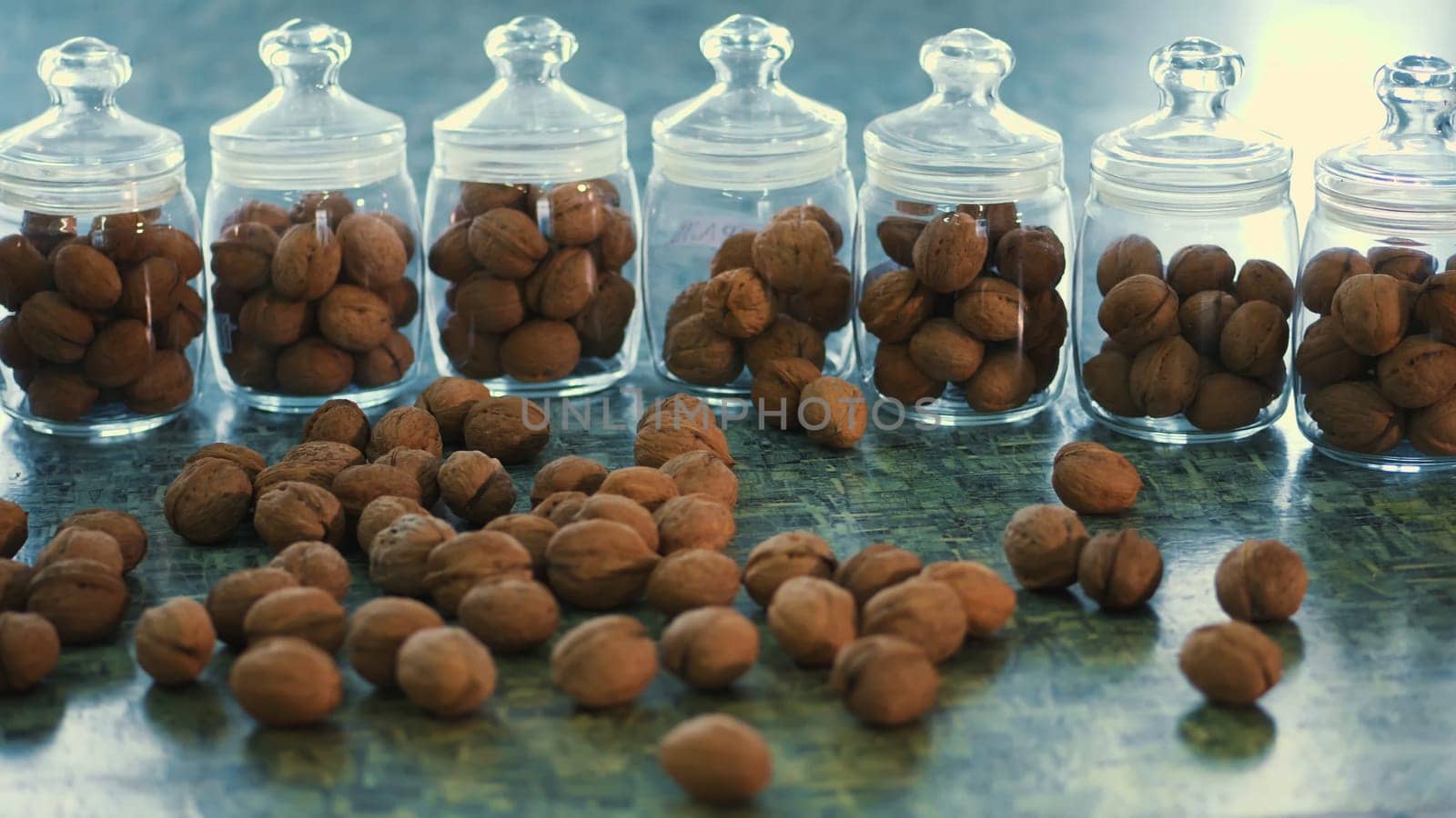 close-up, stored in glass jars are seeds, walnuts, various species grown on breeding, hybrids of nuts. nuts of the best quality. nut for pedigreed horses. High quality photo