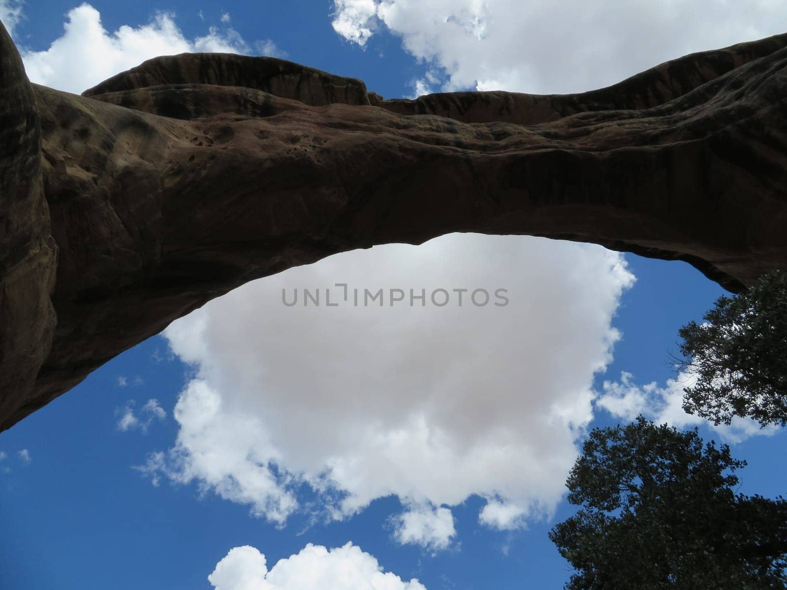 Natural Bridge against Blue Sky with Puffy Clouds, Scenic Southwestern USA Natural Bridges National Monument . High quality photo