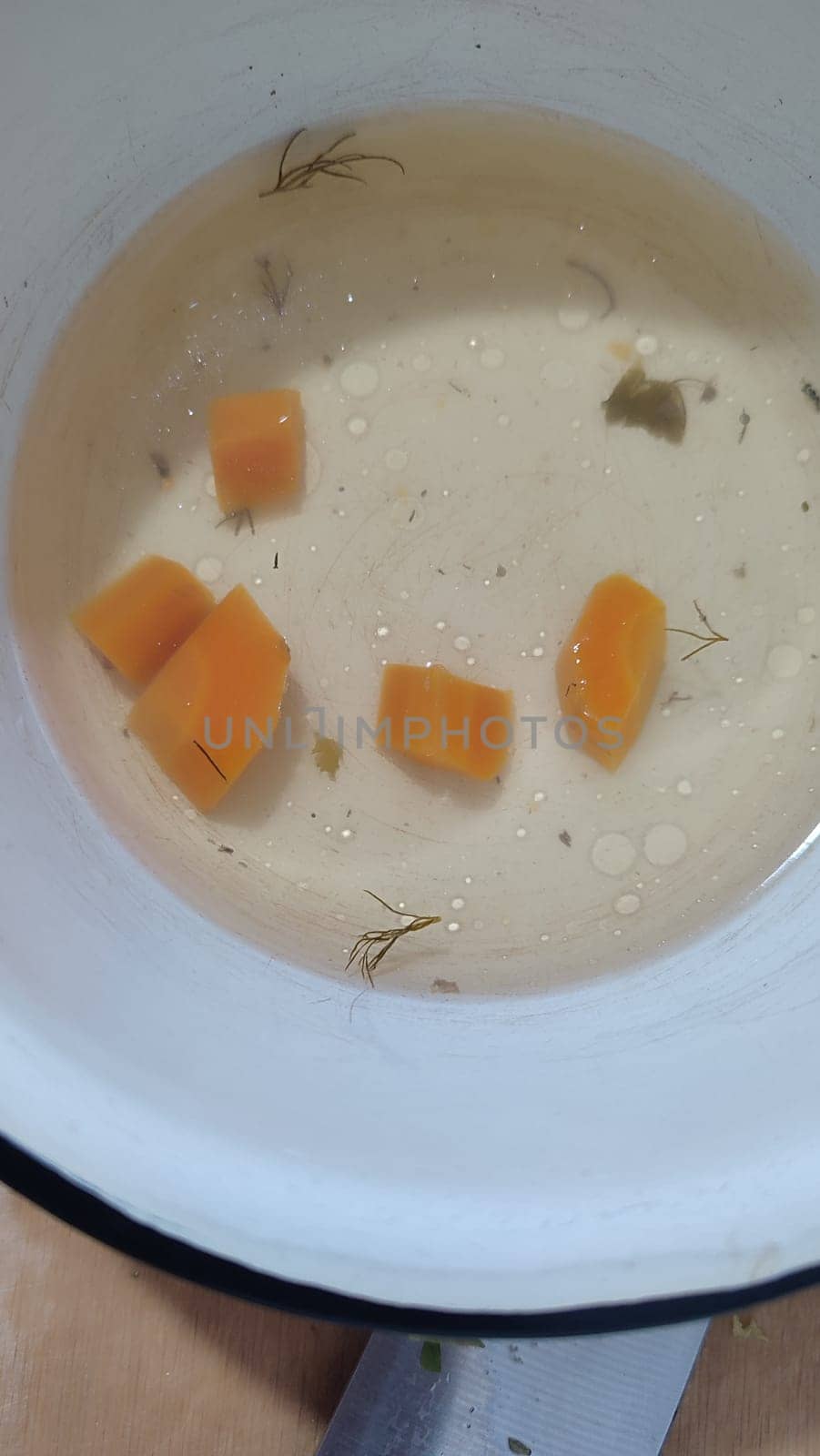 white bowl, broth with carrots, food soup. High quality photo
