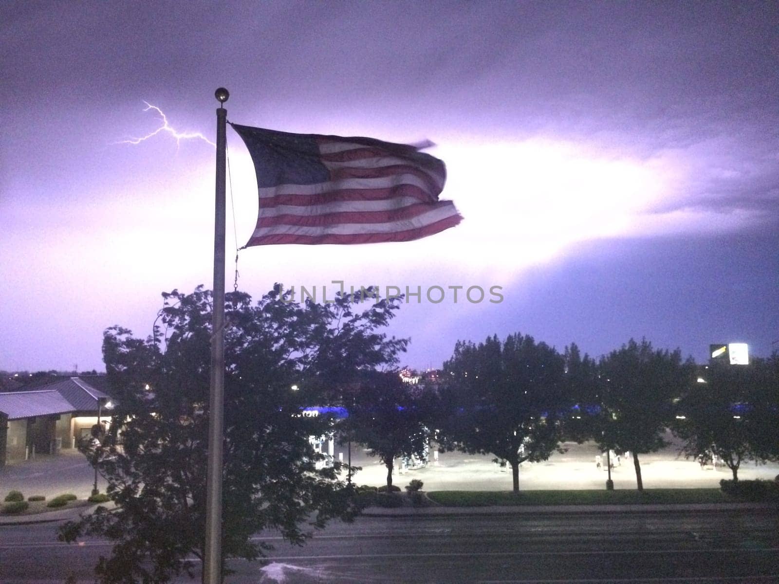 American Flag with Lightning Striking, Dark Sky at Night, Twin Falls, Idaho. High quality photo