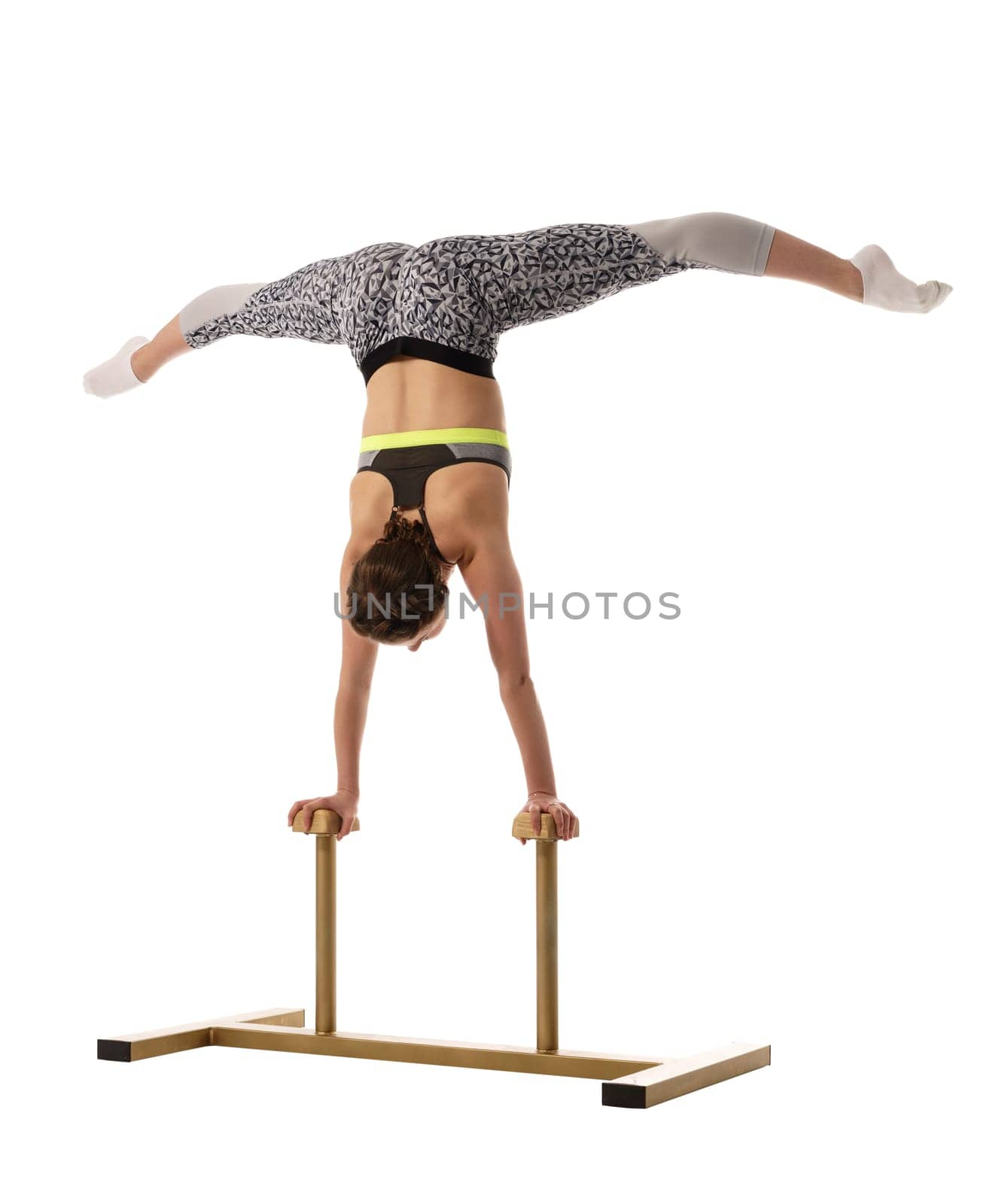 Gymnastics. Flexible girl doing handstand on circus stands
