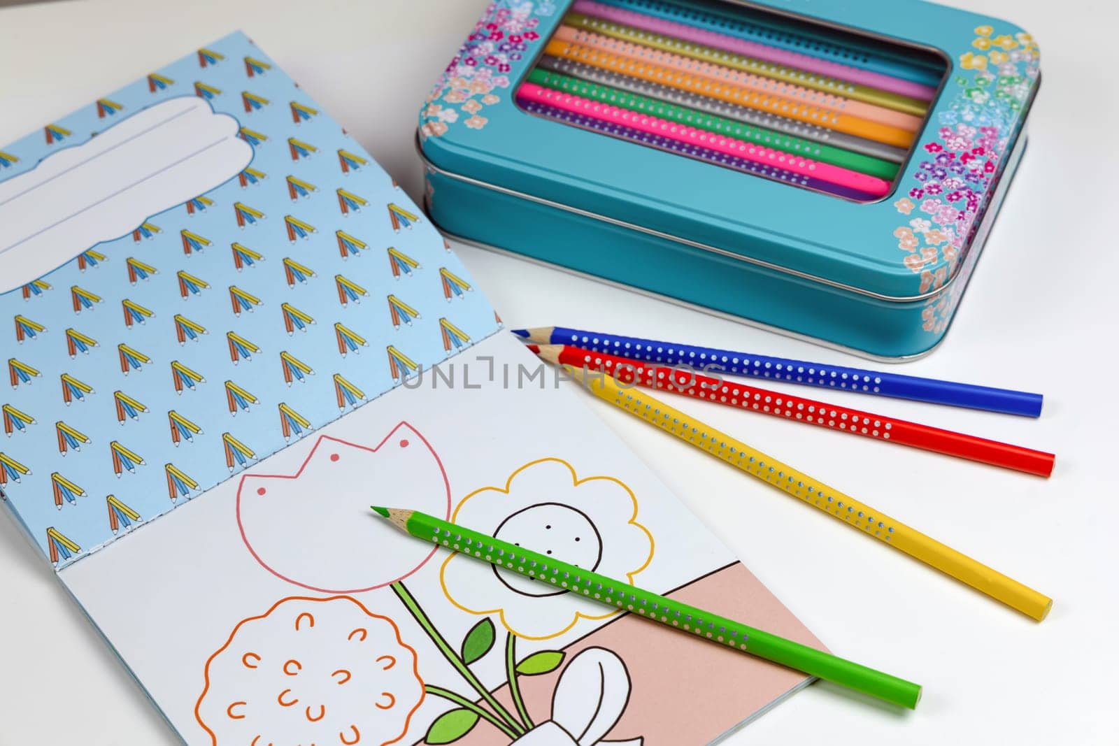 Colored pencils for drawing various colors and coloring book for children. Children's creativity concept.