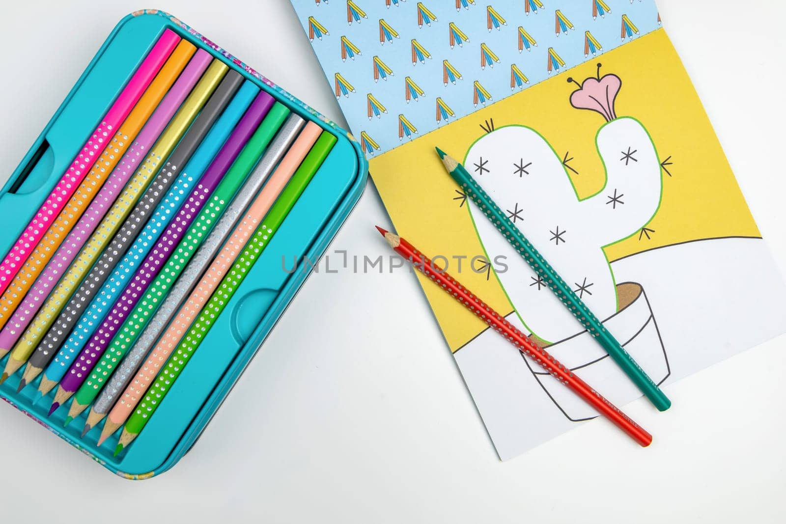 Colored pencils for drawing various colors and coloring book for children. Children's creativity concept.