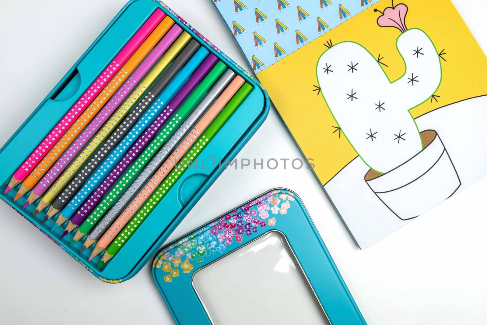Colored pencils for drawing various colors and coloring book for children. Children's creativity concept.