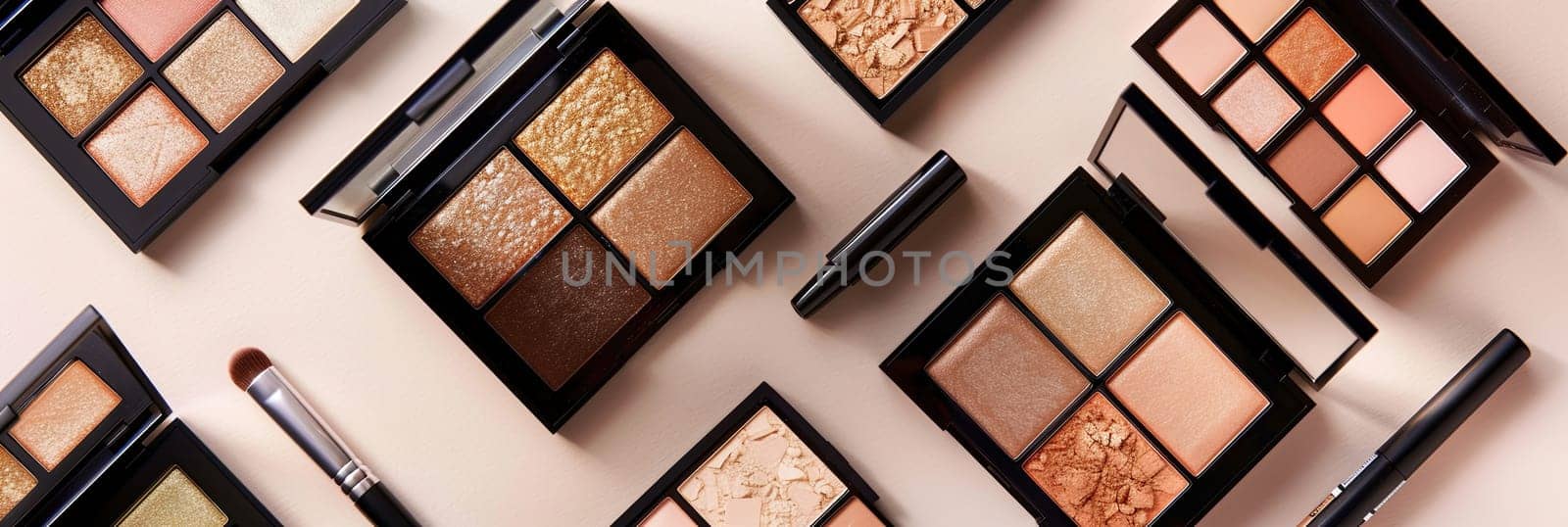 A flat lay of various contouring palettes and highlighters on a light background, featuring rich colors and an elegant, organized aesthetic.