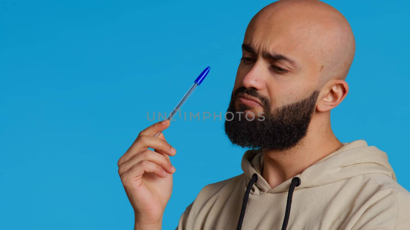 Arab person thinking about solution to the problem, acting pensive and pondering decisions in front of camera. Middle eastern guy trying to come up with new innovative ideas. Camera 2.