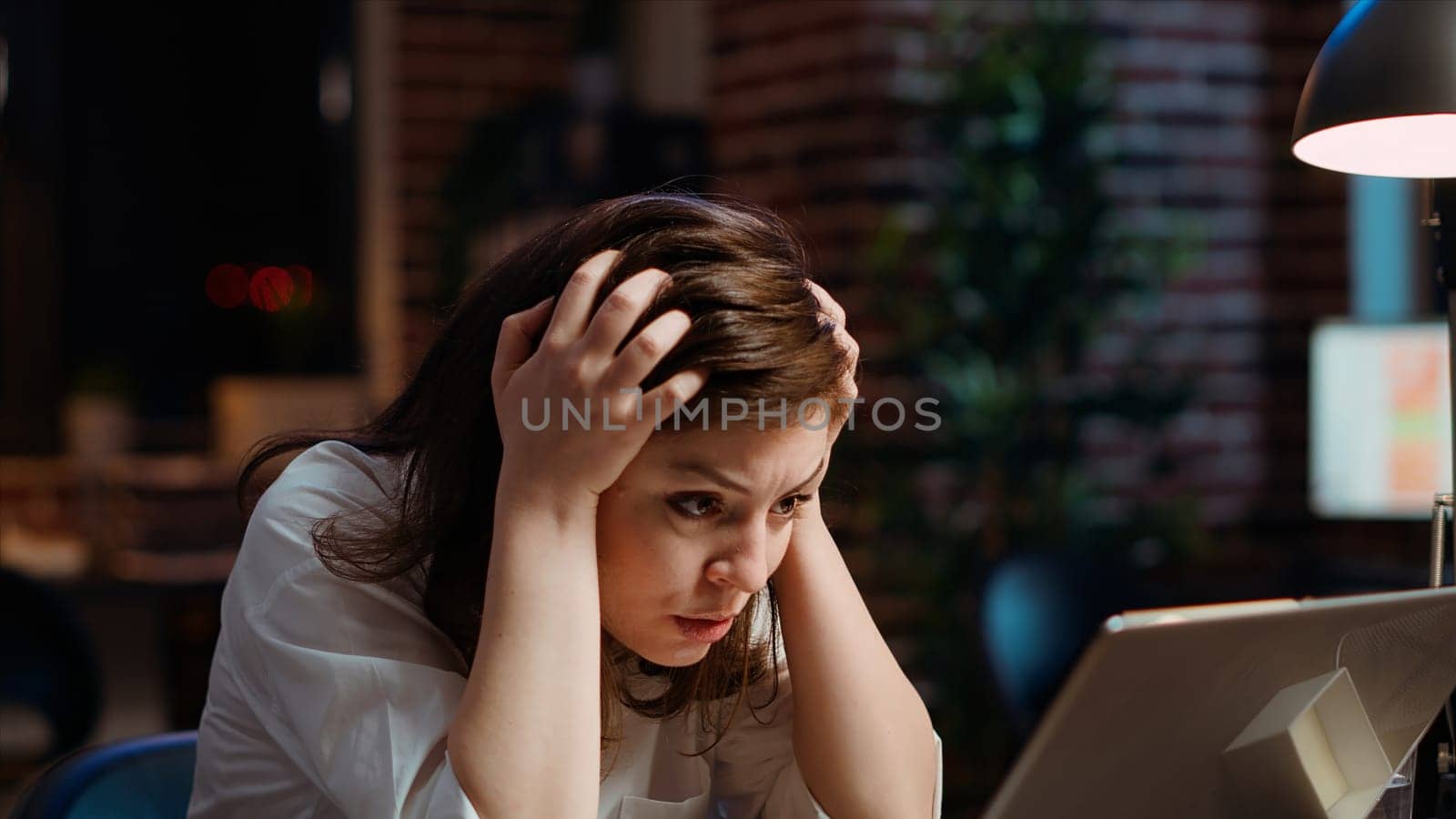 Worker frustrated by mistake she made while inputting data on laptop while working on company project overnight. Close up shot of upset businesswoman realizing error she made