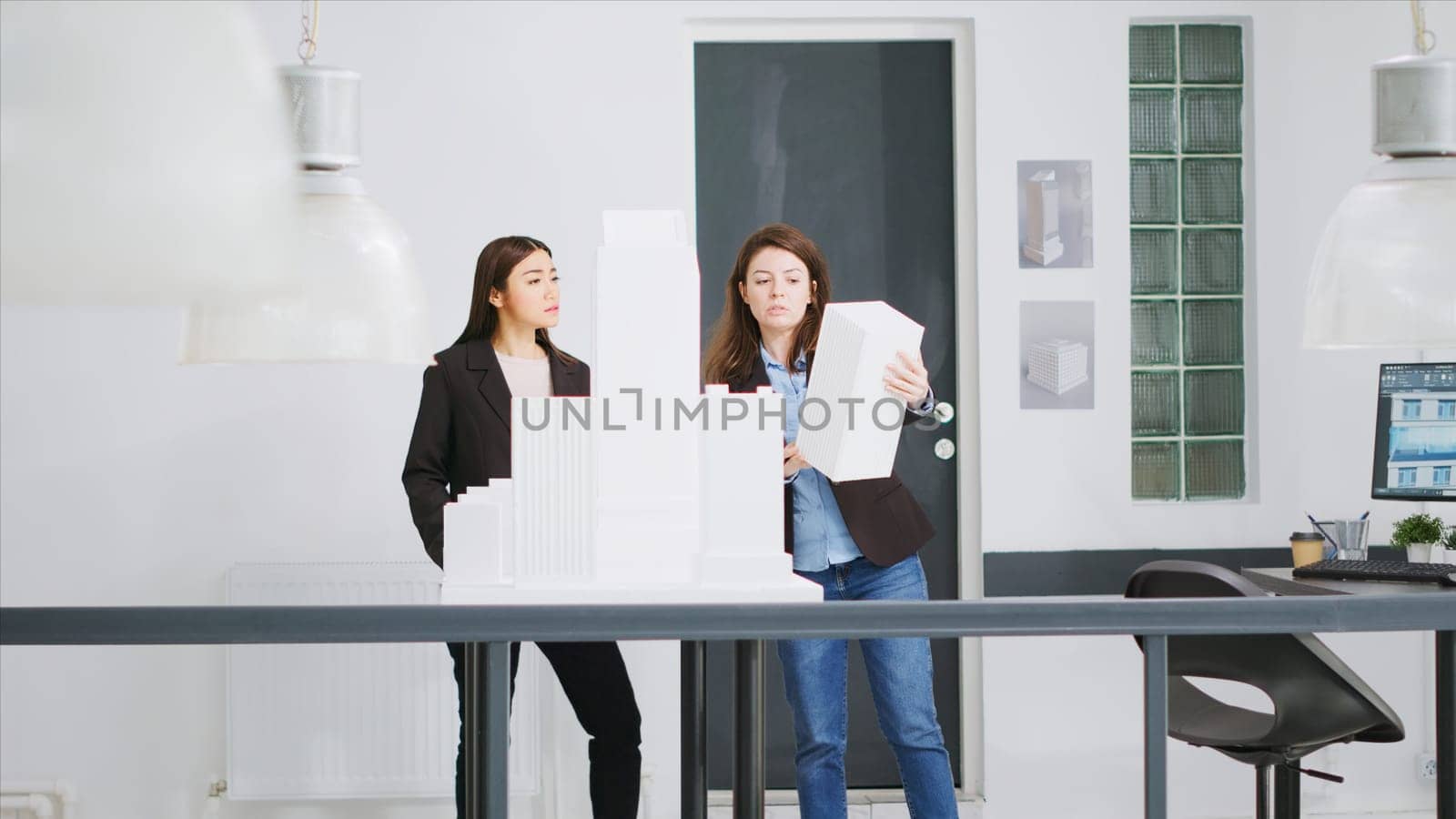 Experts measure models printed in 3D to determine proportions while working on unicorn business expansion goals. Women builders develop architectural blueprints using scale dimensions.