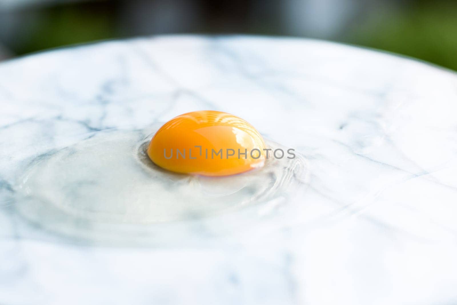 egg yolk on marble - recipe ingredients and homemade cooking styled concept