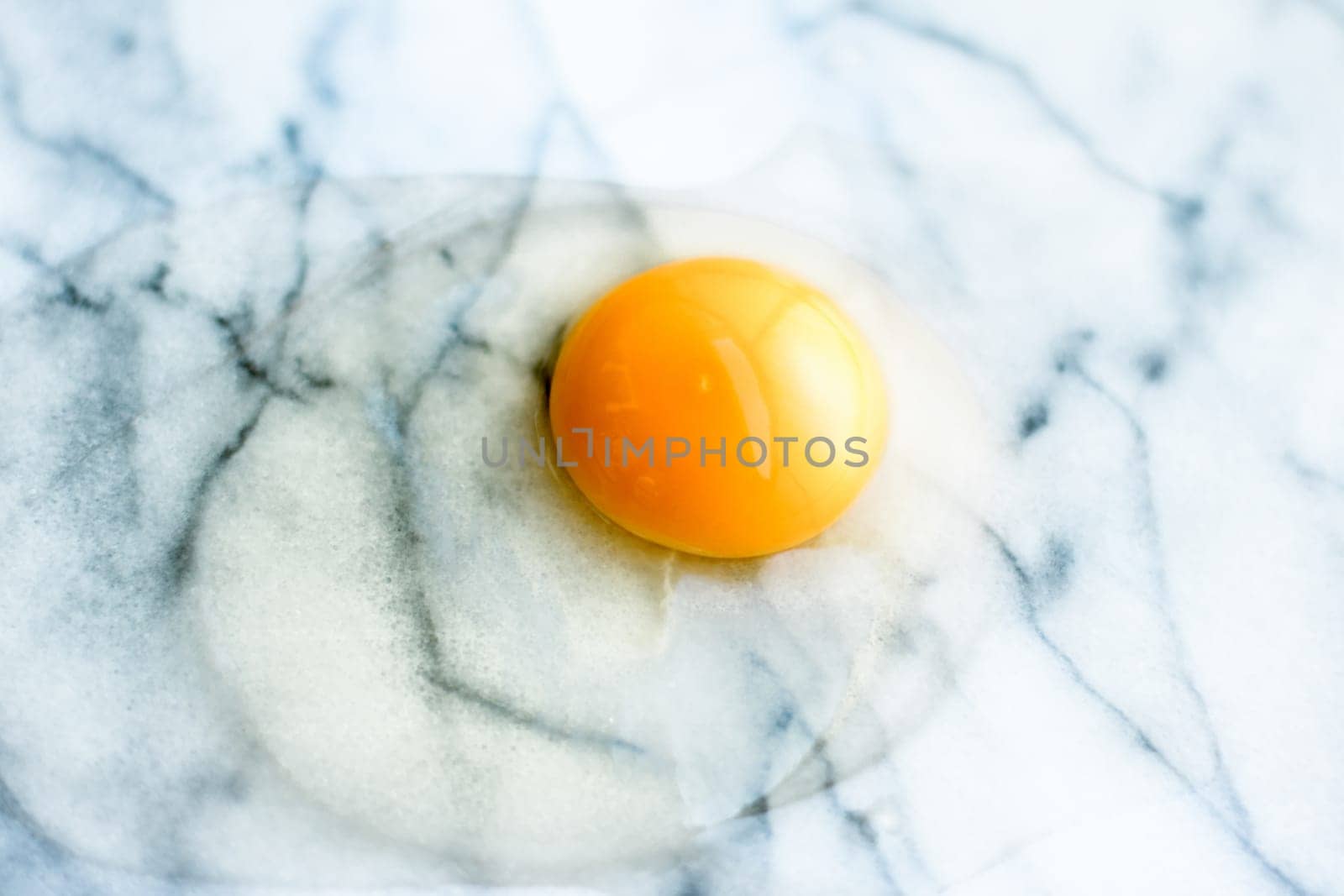 egg yolk on marble - recipe ingredients and homemade cooking styled concept