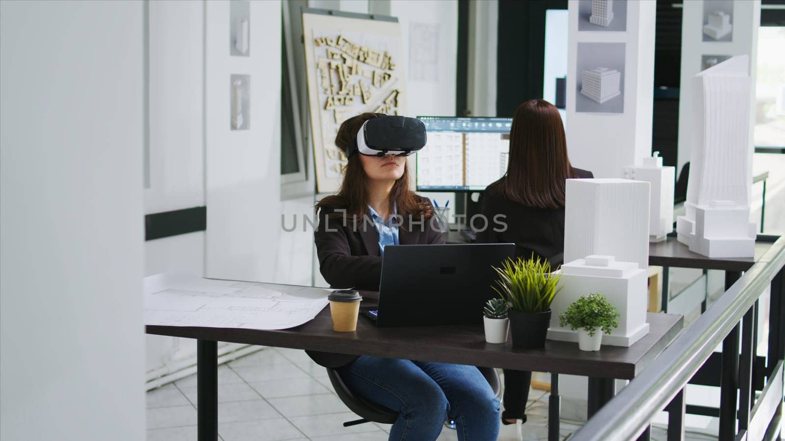 Woman architect working with vr glasses in startup office, modeling floor plan or house blueprint using metaverse artificial intelligence. Industrial engineer developing architectural lines.