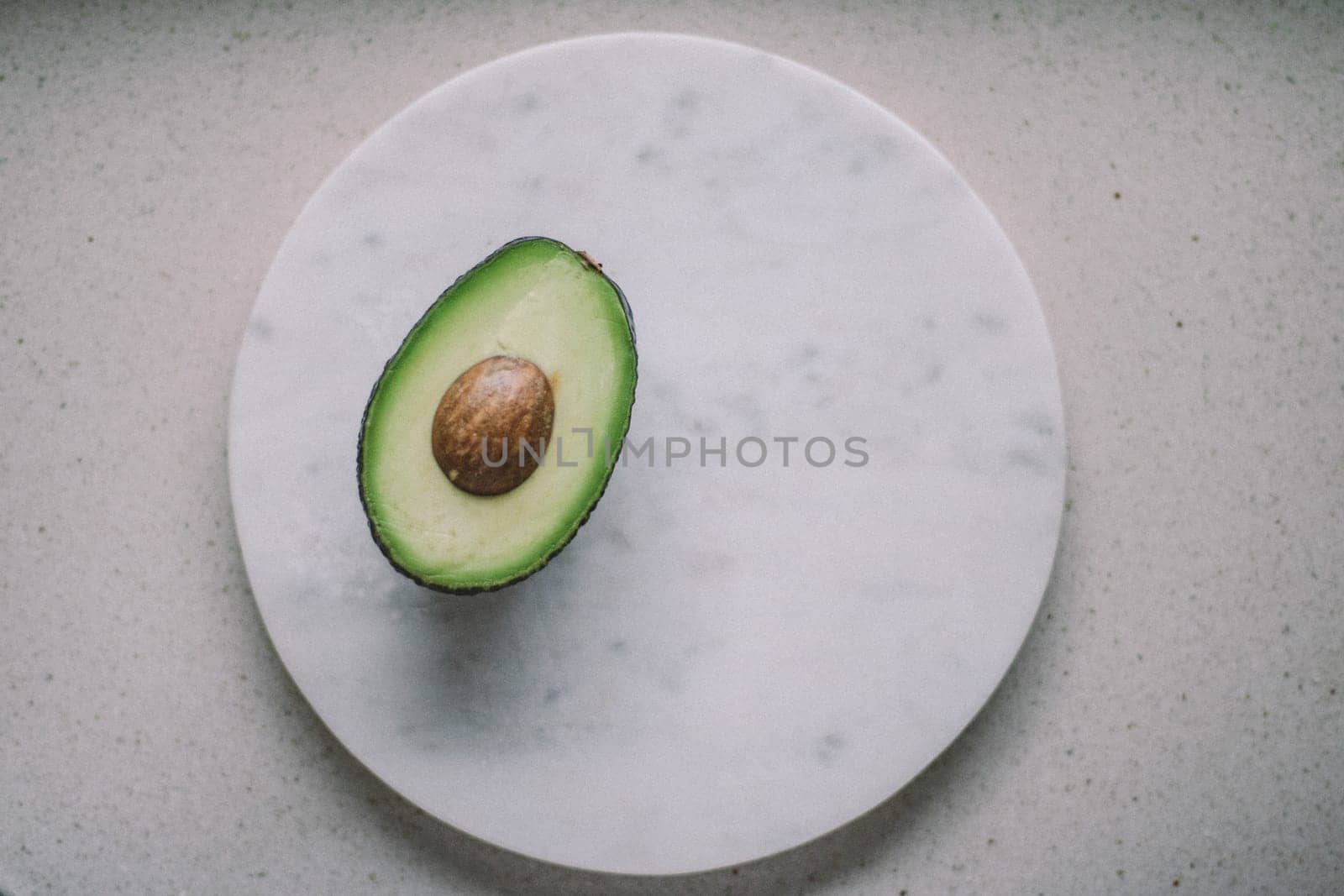 avocado on marble table - organic vegetables and healthy eating styled concept, elegant visuals