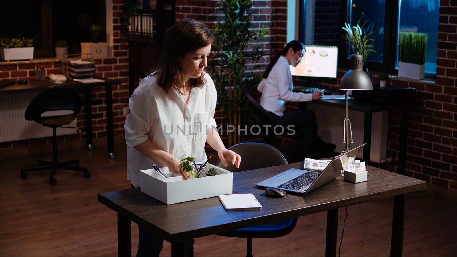 Frustrated employee packing desk belongings after being fired, saying goodbye by DCStudio