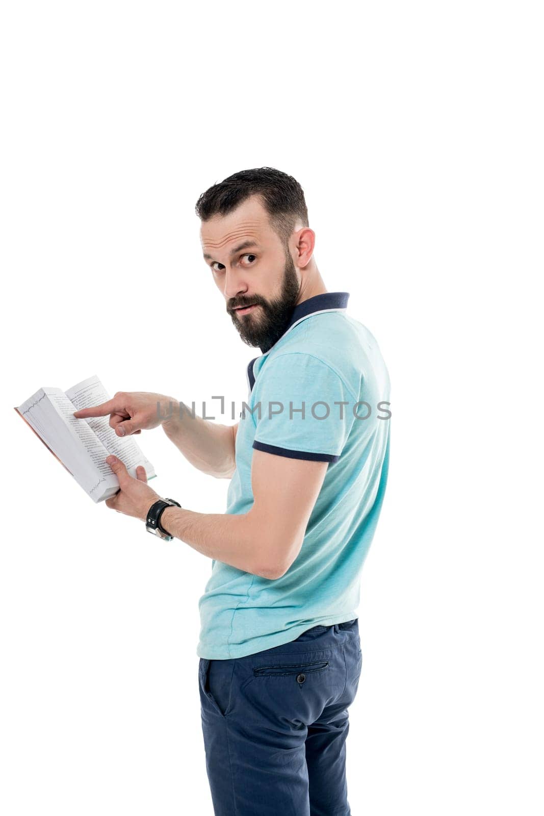 Studio photo of handsome bearded man posing with book