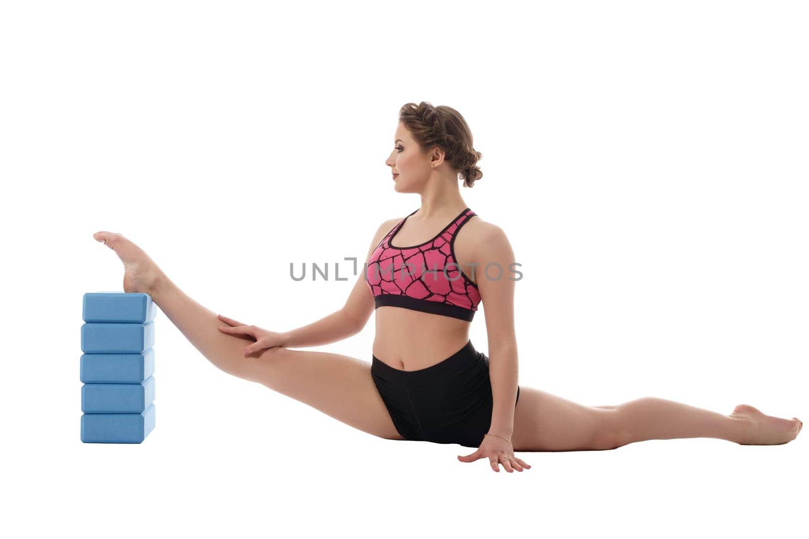 Gymnastics. Woman exercising with bricks for stretching