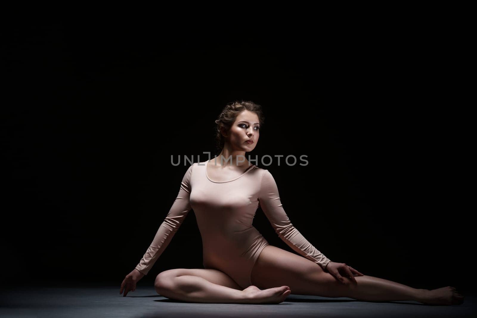 Sport. Attractive artistic gymnast posing in studio