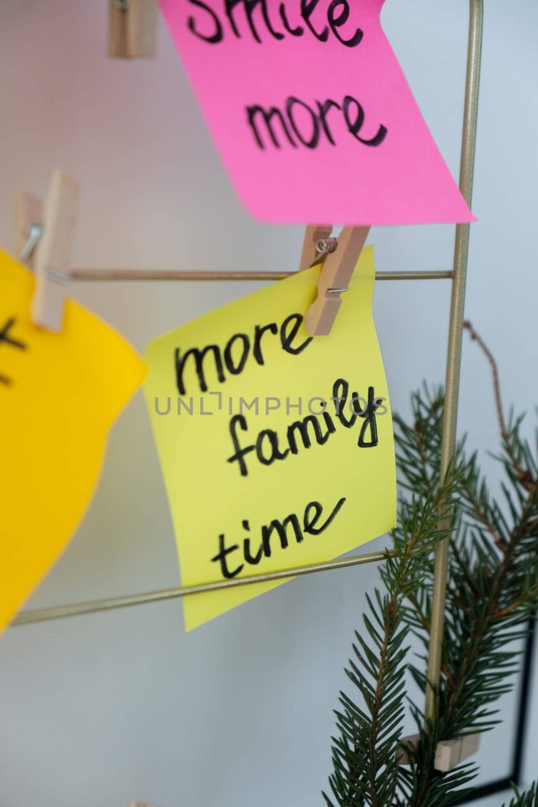 MORE FAMILY TIME goal on Vision board with new year resolutions aims on sticky notes. Preparation for New Year. Concept of planning and setting goals for personal development