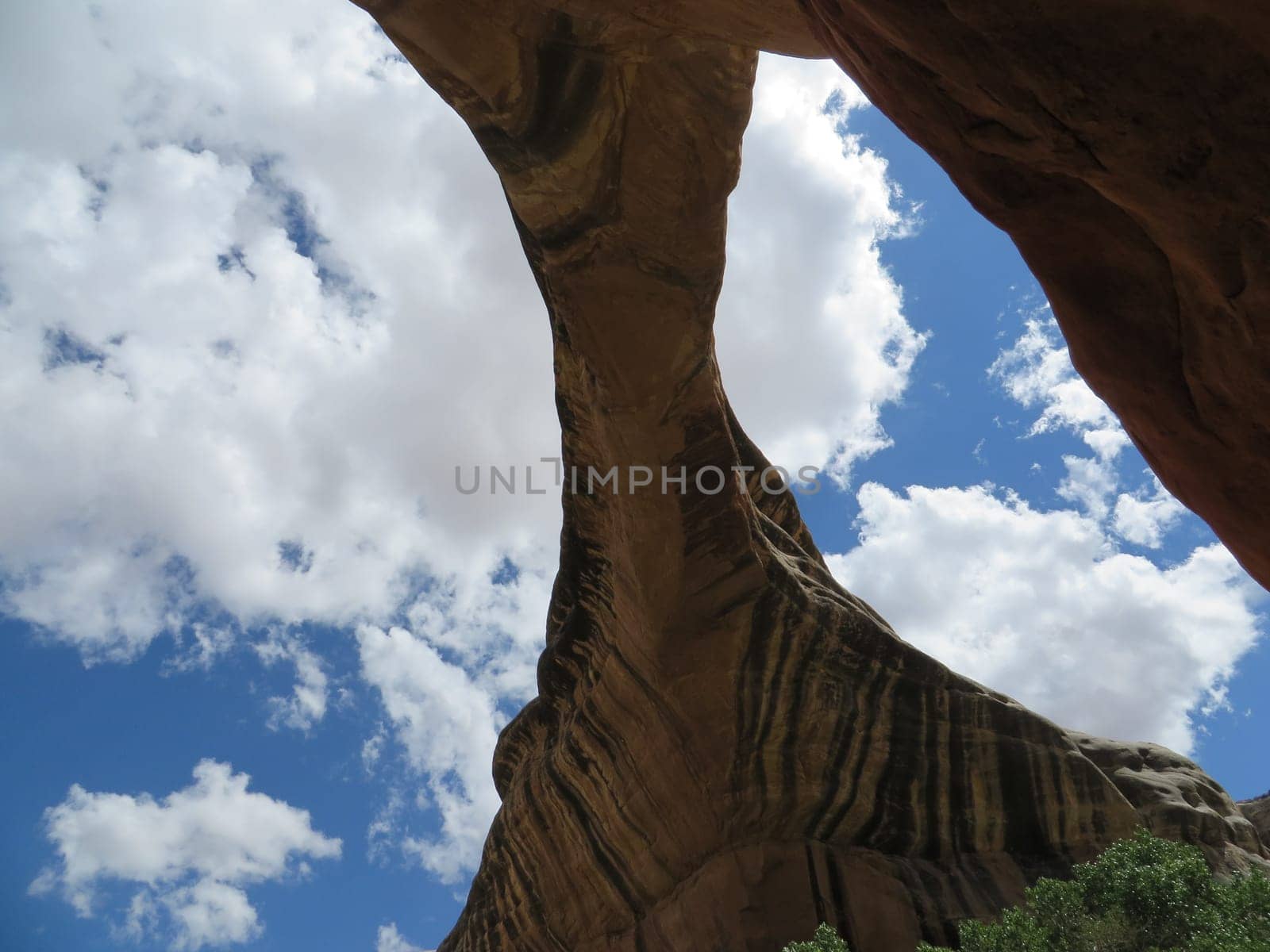 Natural Bridge against Blue Sky with Puffy Clouds, Scenic Southwestern USA Natural Bridges National Monument . High quality photo