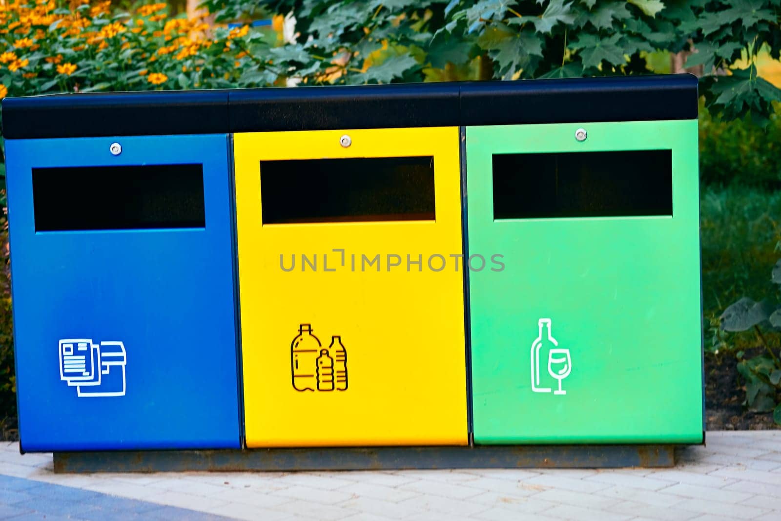 Ecology. Separate waste containers for plastic, paper and glass in a summer park by jovani68