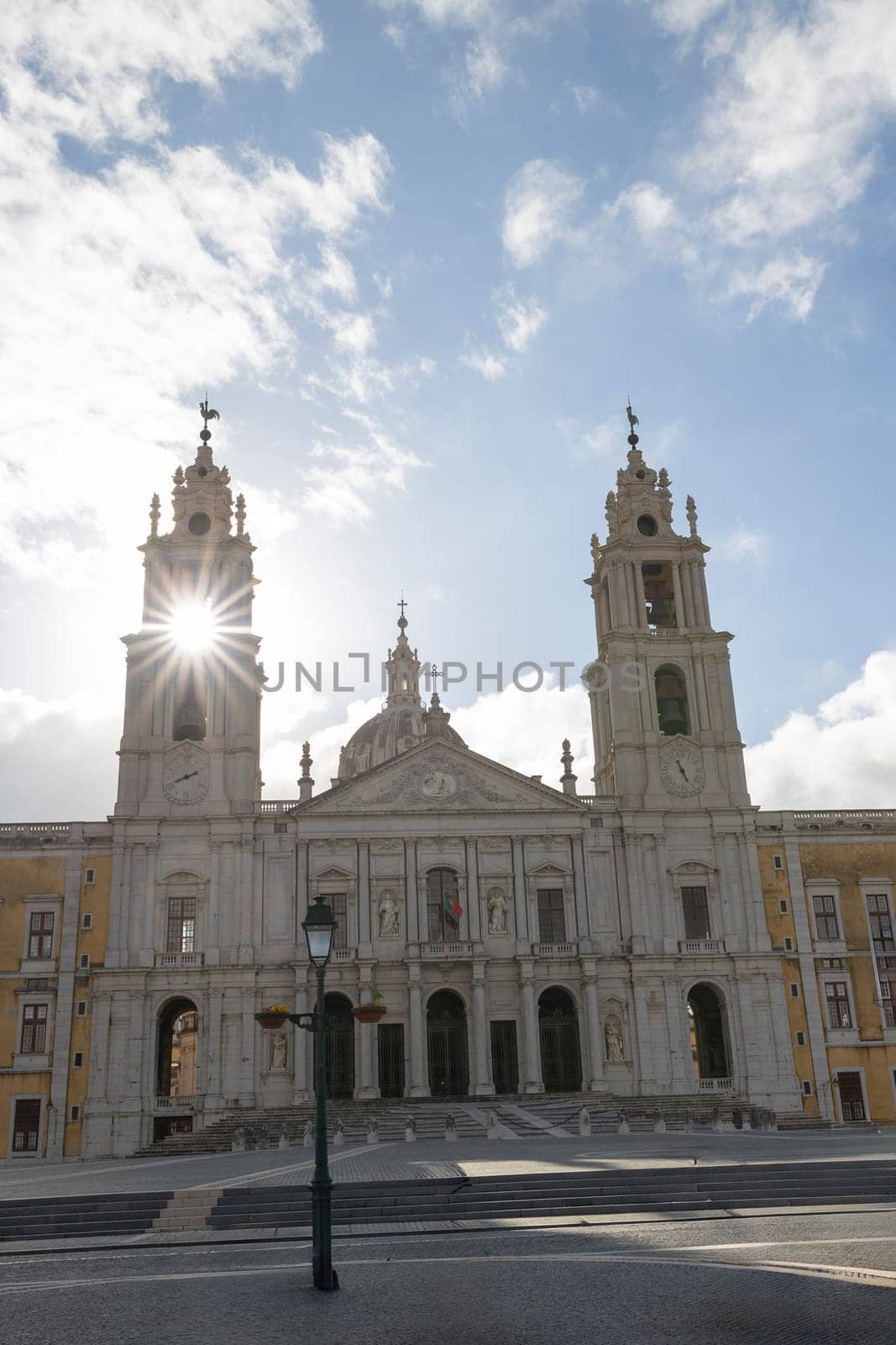 National Palace of Mafra, Portugal - sunny day - the sun is shining on the large tower. wide angle