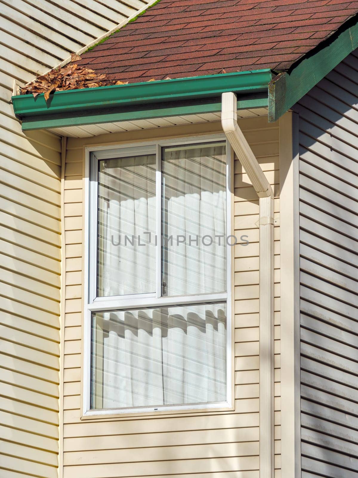 Window and roof of residential house submodule on sunny day.