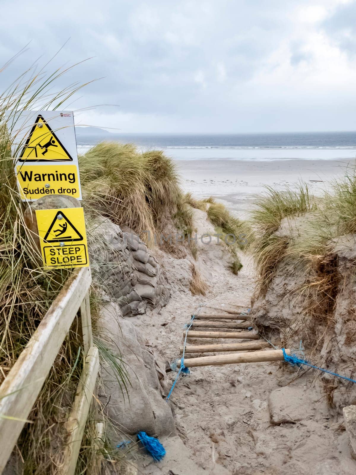 Signs warning of Sudden Drop and Steep Slope at Dooey beach by Lettermacaward in County Donegal - Ireland