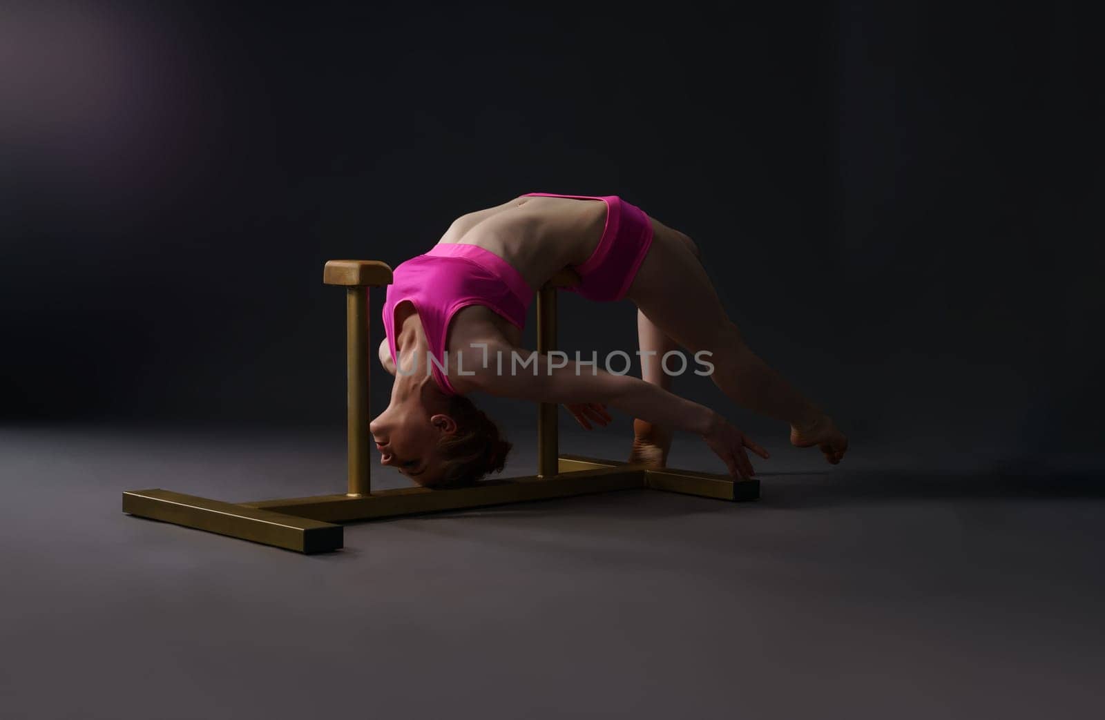 Tightrope walking. Image of red-haired girl training in studio