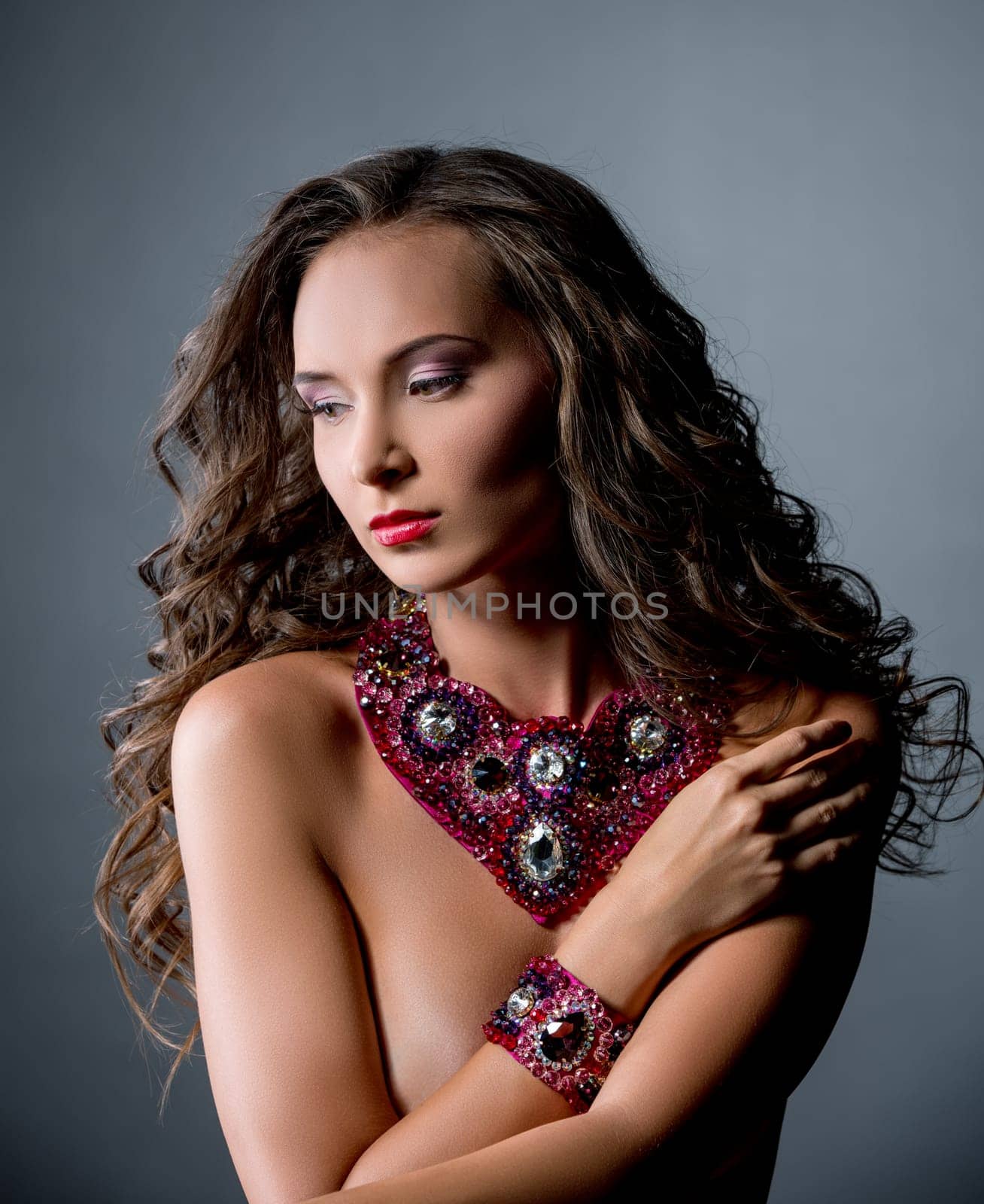 Beautiful nude woman in luxurious necklace and bracelet