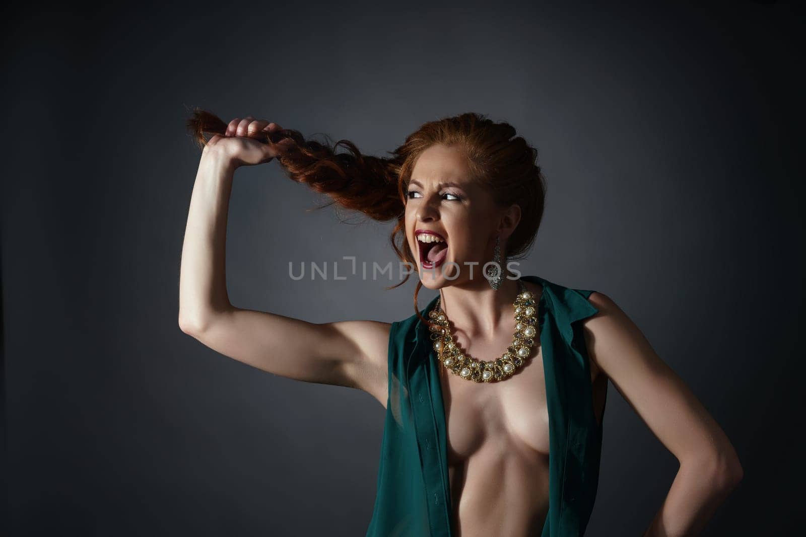 Erotica and luxury. Screaming model advertises jewelry